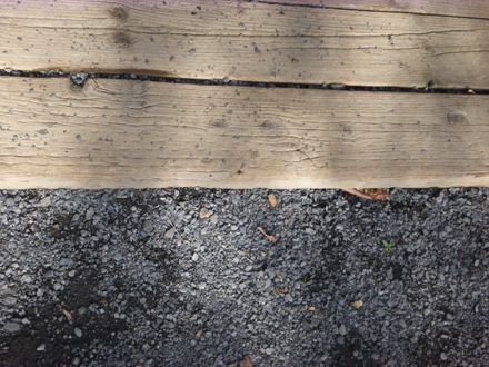 Transition from compacted gravel surface to wooden surface – may be a lip at transition